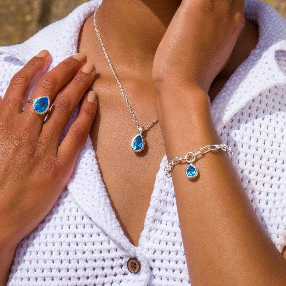 Silver teardrop charm bracelet featuring a Blue Topaz Bracelets Sea Gems Ltd