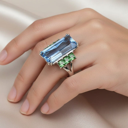 18ct White gold blue topaz ring with tzavorite side stones Ring Buchwald