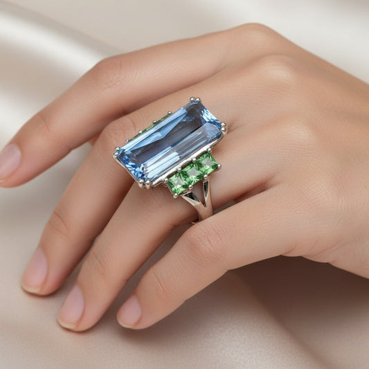 18ct White gold blue topaz ring with tzavorite side stones