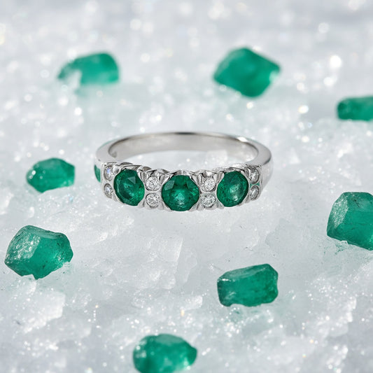Platinum 3 stone emerald ring enveloped with diamonds. Ring Christopher Wharton