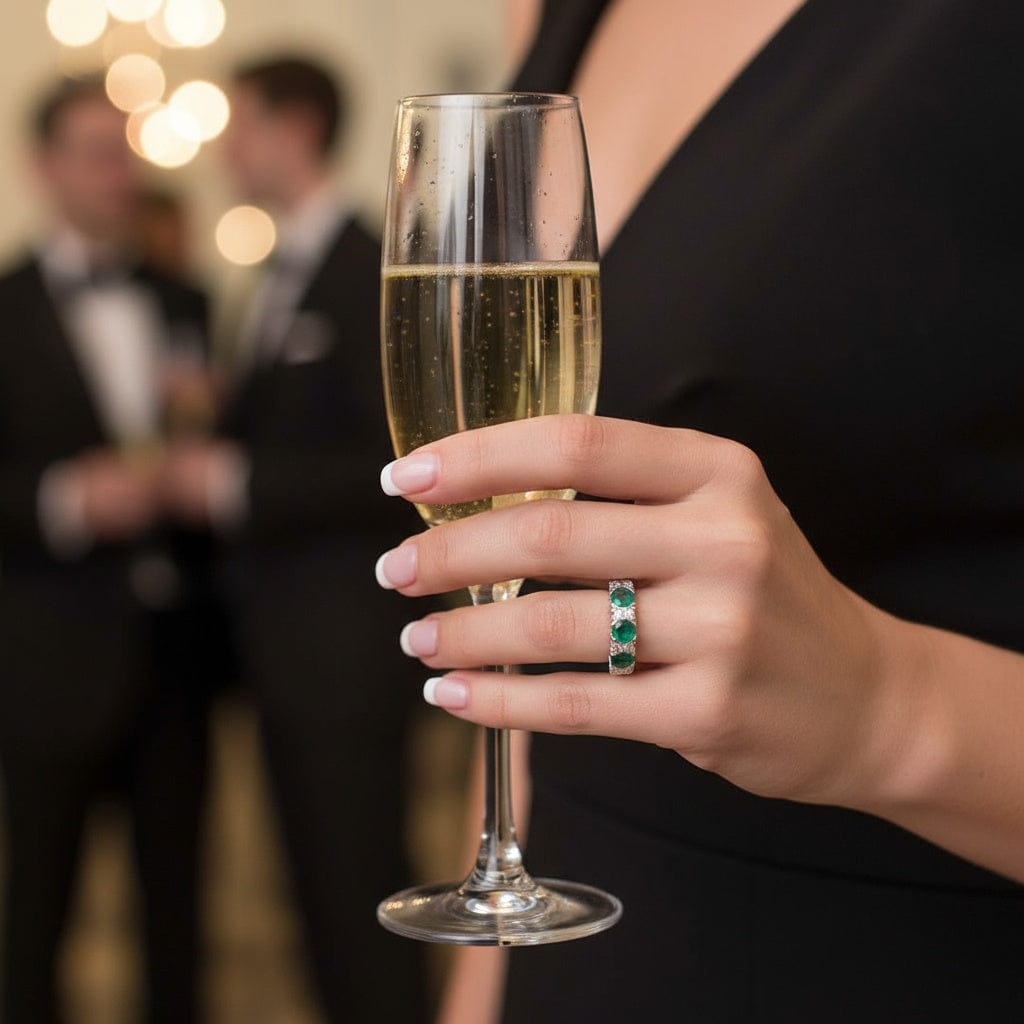 Platinum 3 stone emerald ring enveloped with diamonds. Ring Christopher Wharton